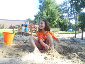A preschooler playing in the sand