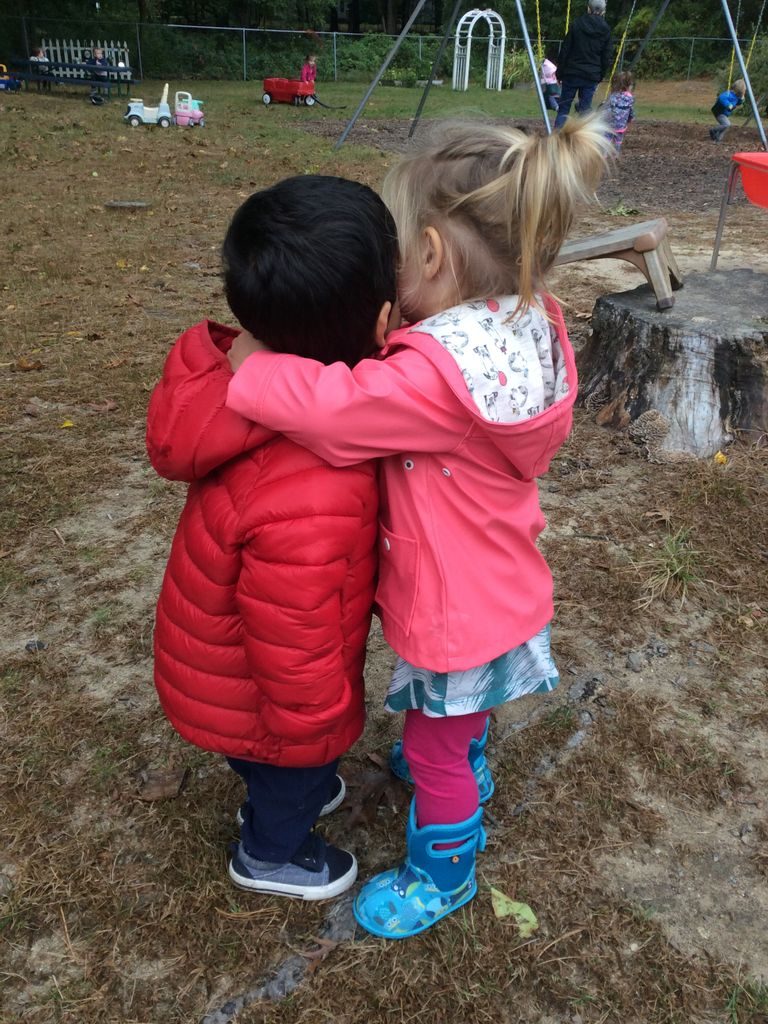 Two toddlers hugging