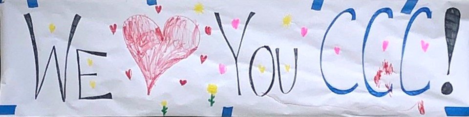 Child's painting with hearts and the words "We love you CCC" 